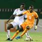 Ivory Coast forward Nicolas Pepe (C) controls the ball with Niger midfielder Mahamane Cisse behind him during an Africa Cup of Nations qualifier in Abidjan Saturday