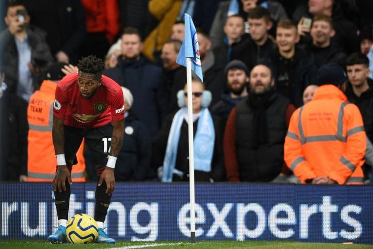 Manchester United's Fred tries to take a corner kick after being pelted with objects from the crowd at Manchester City