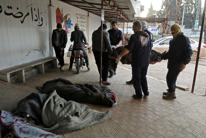 White Helmets rescuers carry bodied of civilians killed in reported Russian air strikes on northwestern Syria