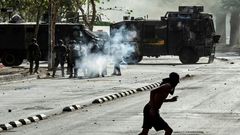 Demonstrators clash with riot police during a protest against President Sebastian Pinera's government in Santiago, on December 10