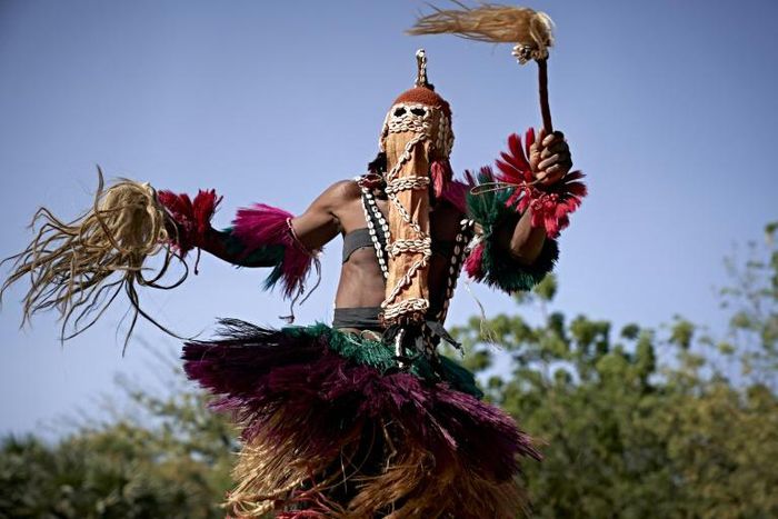 Defiance: A masked man wearing a traditional Dogon costume dances at the opening of the Segou'Art Festival, which takes place despite the threat of jihadist attacks