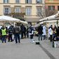 A municipal policeman checks people are keeping their distance at the fruit and vegetable market in piazza San Cosimato, in the Rome district district of Trastevere
