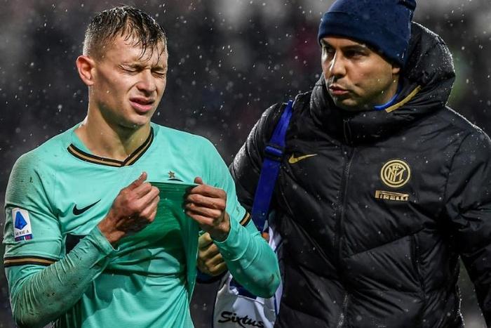 Inter Milan's Italian midfielder Nicolo Barella (L) hurt his knee during a rain-soaked Serie A match at Torino