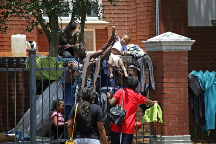 Several hundred asylum-seekers scaled the iron railings of the  United Nations High Commissioner for Refugees office in Pretoria seeking protection