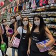 Shop sellers wear masks in the Brazilian city of Sao Paulo, where a state of emergency has been declared over the coronavirus pandemic