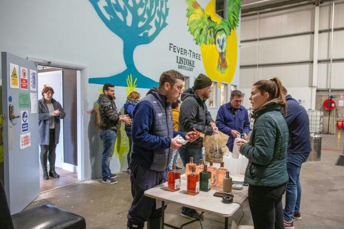 Customers queued out of the front door of the warehouse distillery and into the car park of the industrial estate outside, obeying strict "social distancing" measures
