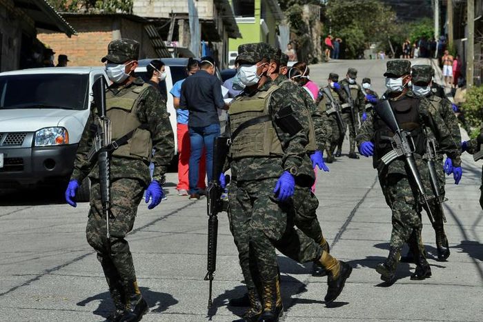 Soldiers assist health personnel in Tegucigalpa, Honduras on March 17, 2020 after two new cases of the new coronavirus were confirmed