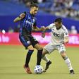 Montreal's Maxi Urruti (left) tackles New England's Diego Fagundez (right) in their season-opening Major League Soccer clash