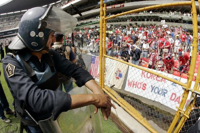 Police watch over fans during a World Cup qualifier between the USA and Mexico at Mexico City's Azteca Stadium