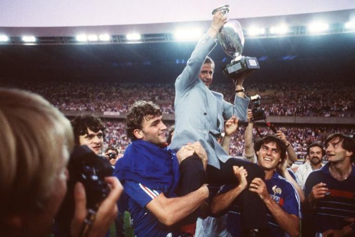 (FILES) Michel Hidalgo,  carried by several France players, holds aloft the European Championship trophy after their 2-0 win over Spain in the final in 1984