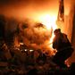 A volunteer firefighter battles a blaze after a night-time air strike on the Idlib province town of Ariha