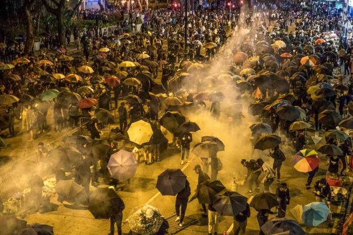 The US Congress has antagonized Beijing by passing legislation that supports human rights and democracy in Hong Kong, where months of protests and unrest have rocked the semi-autonomous Chinese territory
Protesters react as police fire tear gas while t...