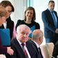 German Chancellor Angela Merkel (L) reaches out to try and shake hands with German Interior Minister Horst Seehofer