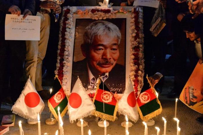 Slain Japanese doctor Tetsu Nakamura (portrait pictured at a vigil held in Kabul the day after he was killed) had devoted 35 years of his life to healing Afghans and Pakistanis