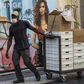 A worker wears a face mask as a precautionary measure against the spread of the new coronavirus as he pulls a cart with boxes near La Moneda Presidential Palace in Santiago, on March 16, 2020