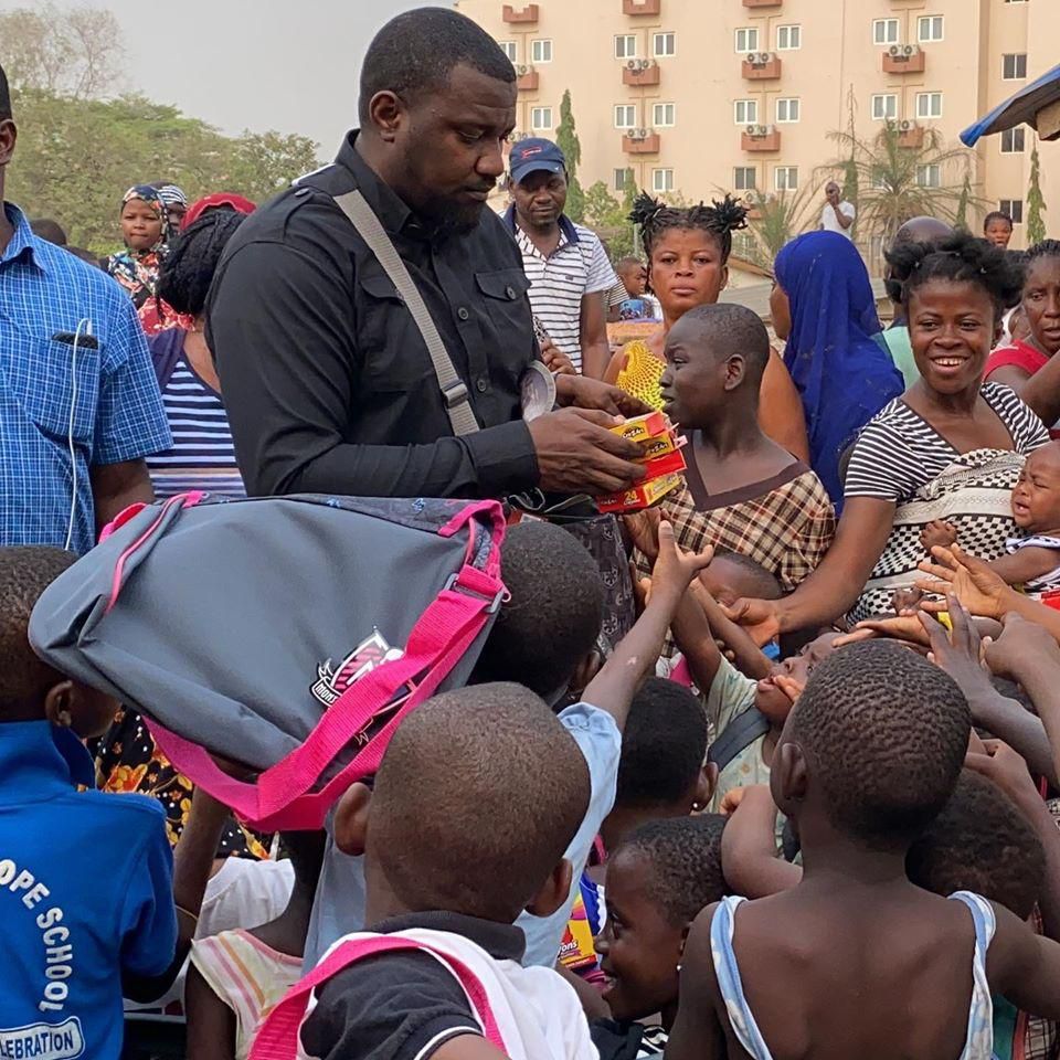 John Dumelo donates hundreds of school bags, exercise books to kids