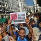 Algerian protesters chant anti-government slogans near the parliament building in Algiers on October 13, 2019 against the military's role in politics and a draft energy law