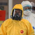 Russian President Vladimir Putin wears protective gear during a visit to a hospital with patients infected with the COVID-19 novel coronavirus