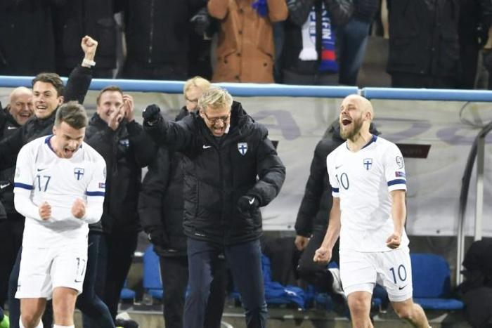 Finland celebrate qualifying for their first appearance at the finals of a major tournament