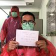 Doctor Muhammad Farras Hadyan, wearing a raincoat because of a shortage of proper protection gear, poses for a selfie during a break from treating patients with coronavirus, in Jakarta