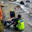 This picture released by Indonesia's national search and rescue agency (BASARNAS) shows rescue personnel retrieving a victim after a bus careered into a 150-metre deep ravine and ended up in a river, near Perahu Dipo village in South Sumatra