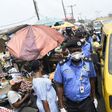 Lagos Police Commissioner Hakeem Odumosu squeezes his way through a market to monitor compliance with  measures to curb the spread of coronavirus