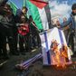 Palestinians angry at controversial peace proposals unveiled by US President Donald Trump burn an Israeli flag during a protest in the Gaza Strip city of Khan Yunis
