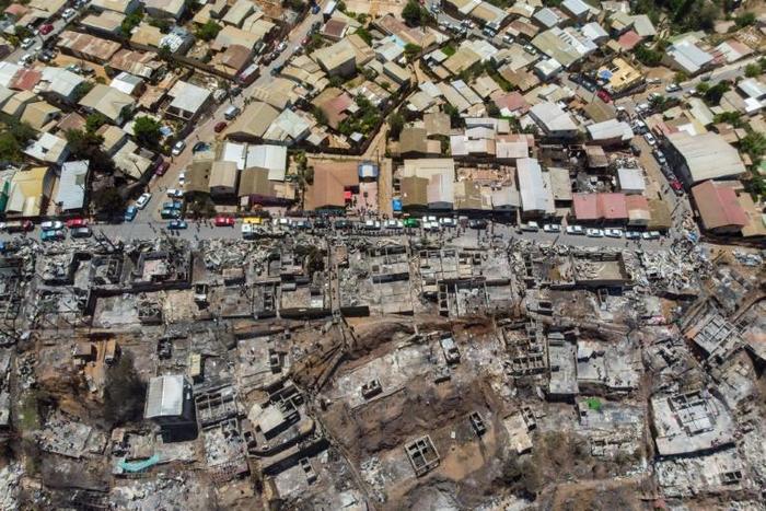 An aerial view of burned houses after a forest fire at the Rocuant hill in Valparaiso, Chile, on December 25, 2019