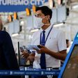 An airline staff member wears a mask while working at Arturo Merino Benitez International Airport in Santiago, Chile -- the new coronavirus has spread into Latin America and Africa