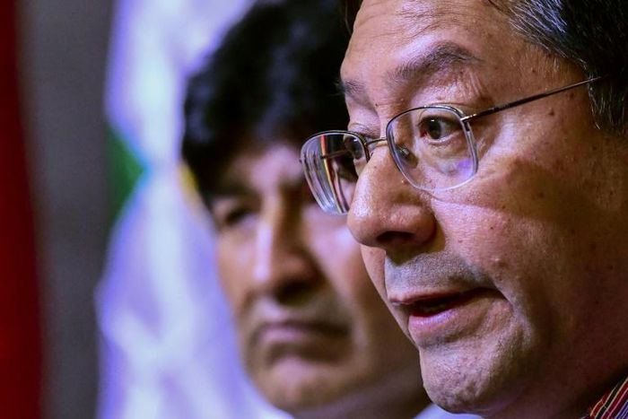 Former Bolivia president Evo Morales (in the background) and presidential candidate Luis Arce face a race against time to register for May's general election
