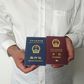An unidentified Chinese Uighur man in the city of Medina holds his expired Chinese passport (red) and a one-way travel document (blue) issued in its place by the Chinese mission in Saudi Arabia