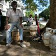 A man waits to replace an empty propane gas drum in Havana, on January 14, 2020: the Communist island is facing widespread fuel shortages in the wake of new US sanctions
