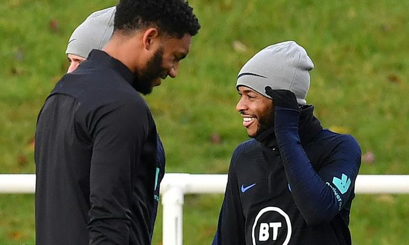 Defender Joe Gomez (left) and forward Raheem Sterling attend an England team training session on November 12, 2019