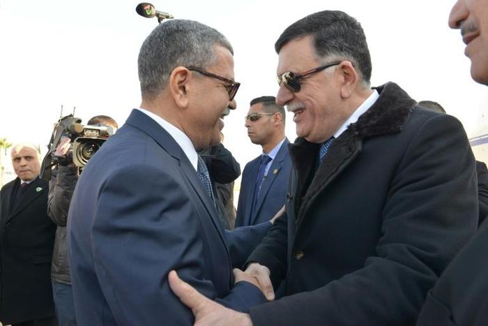 A handout picture released by the official Algeria Press Service (APS) on January 6, 2020 shows Algeria's Prime Minister Abdelaziz Djerad (L) receiving Libya's UN-recognised Prime Minister Fayez al-Sarraj upon his arrival in Algiers