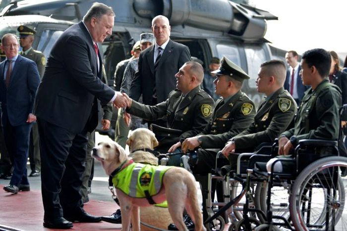 US Secretary of State Mike Pompeo (L) shakes hands with Colombian policemen victims of landmines during his visit at an anti-drug base in Bogota