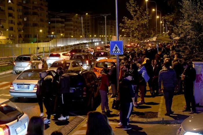 Residents gathered outdoors in Tirana