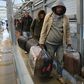 Palestinian labourers enter Israel to work after being told to decide whether to stay there throughout the coronavirus crisis or return to the West Bank