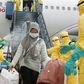Health officials disinfect the evacuees from Wuhan, who will be quarantined on the island of Natuna for two weeks