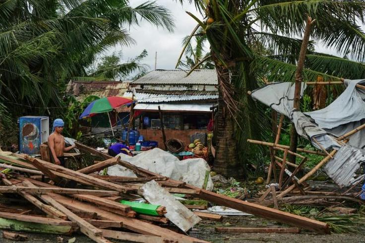 Typhoon Phanfone swept across the central Philippines on Christmas Day, tearing roofs off houses