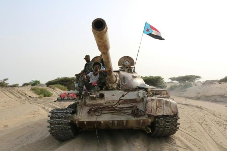 Fighters of the UAE-trained Security Belt Force, dominated by members of the secessionist Southern Transitional Council (STC), ride atop a tank in Yemen's southern coastal town of Shuqrah, east of Aden, in August this year