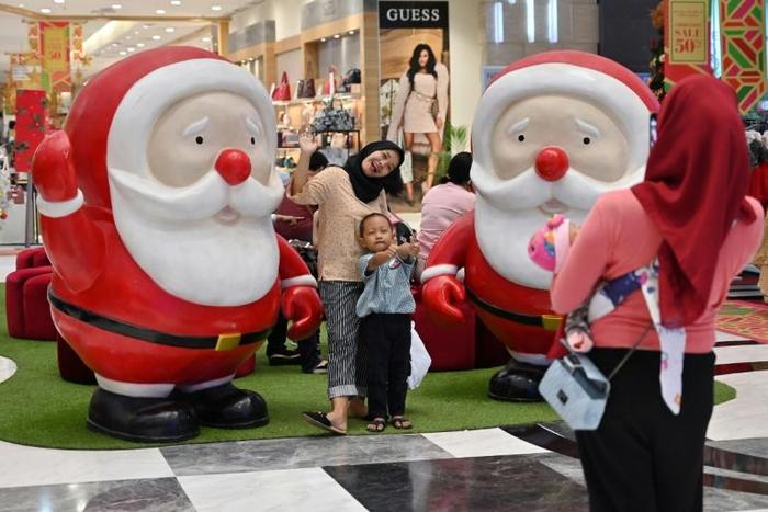 Despite being a Muslim-majority nation, many Indonesians are happy to take part in Christmas festivities regardless of their religion -- although conservative Islamic groups frequently target public displays
