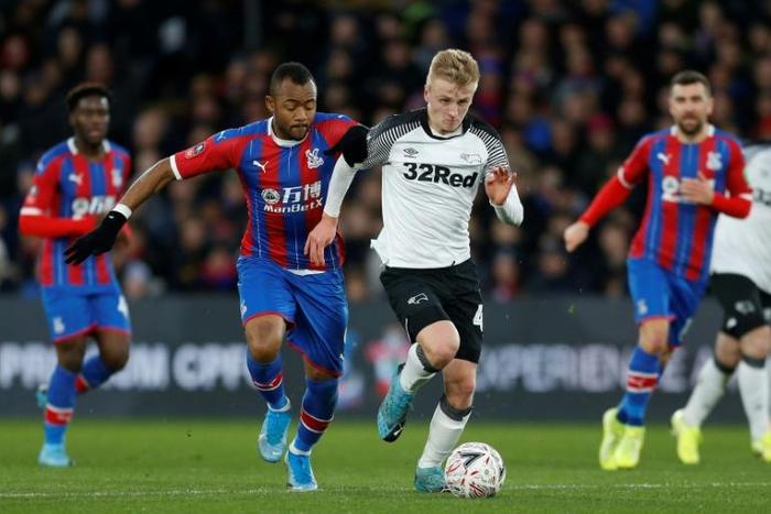 Ghana striker Jordan Ayew (L) vies with Derby County's English midfielder Louie Sibley during Crystal Palace's surprise FA Cup defeat