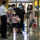 Passengers have their temperature checked on arrival at Hong Kong International Airport