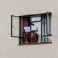 A man in mandatory quarantine in Kenya holds a sign reading "help me" out of the window of a facility in Nairobi