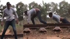 Daring man surprisingly survives after lying on a railway for a speeding train to pass over him (video)
