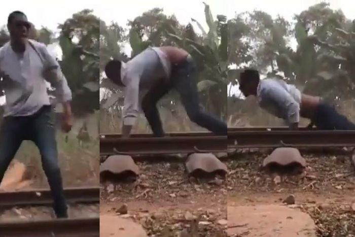 Daring man surprisingly survives after lying on a railway for a speeding train to pass over him (video)