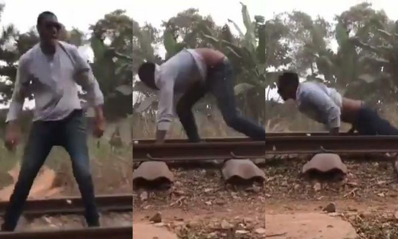 Daring man surprisingly survives after lying on a railway for a speeding train to pass over him (video)