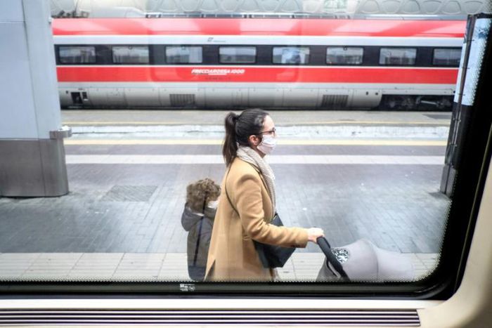 Passengers wear protective masks at Milan's main railway station following security measures taken in northern Italy against  the novel coronavirus. Milan is just north of the main centre of infection.