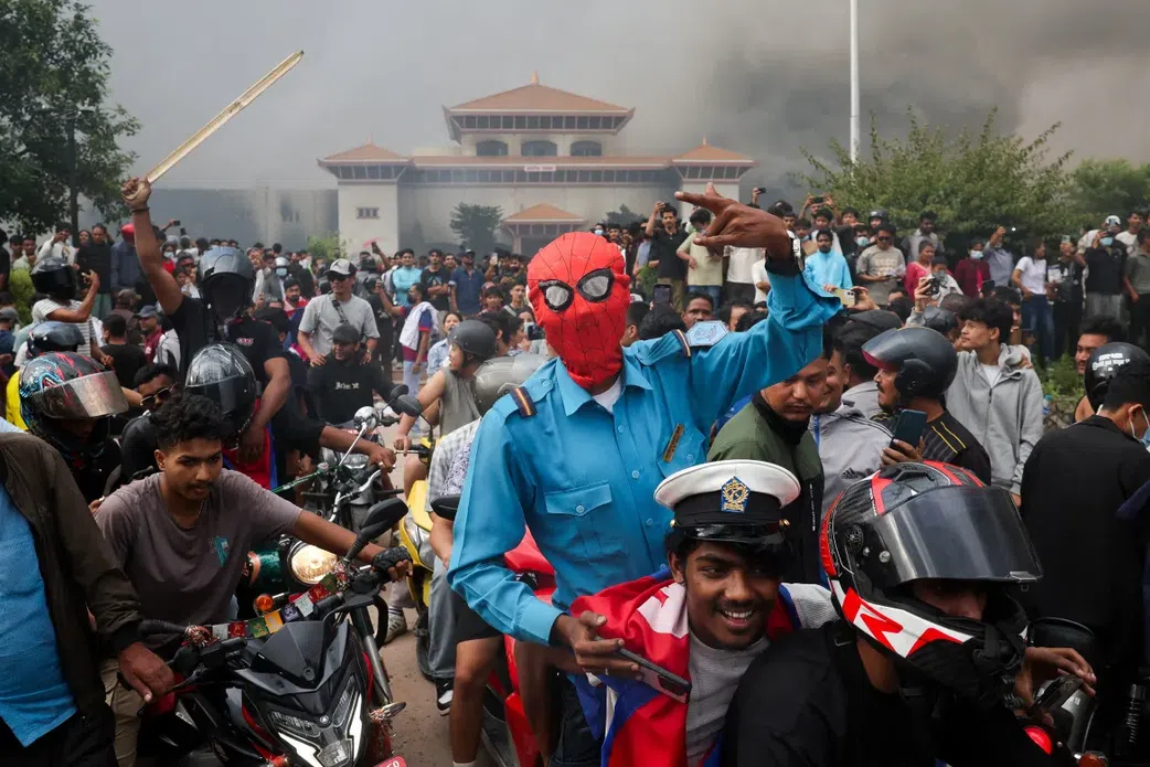 Smoke billows from the Federal Parliament of Nepal complex, where fires were ignited on September 9, 2025, during protests against the killings of 19 people a day earlier. [Adnan Abidi/Reuters]