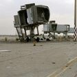 A fighter loyal to Libya's UN-recognised unity government  surveys the abandoned jet bridges at Tripoli's devastated civilian airport following its recapture on Wednesday